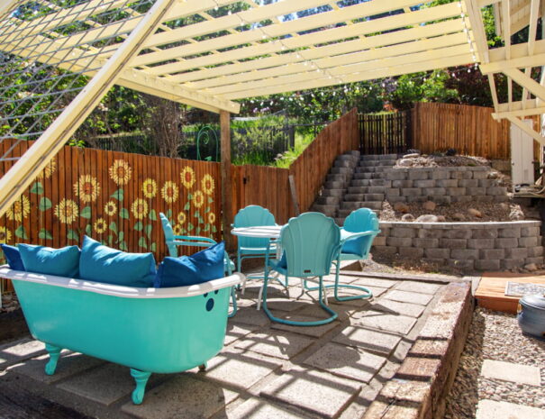 Outdoor patio with 4-seat dining set, and clawfoot tub sofa.