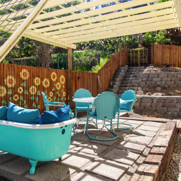 Outdoor patio with 4-seat dining set, and clawfoot tub sofa.