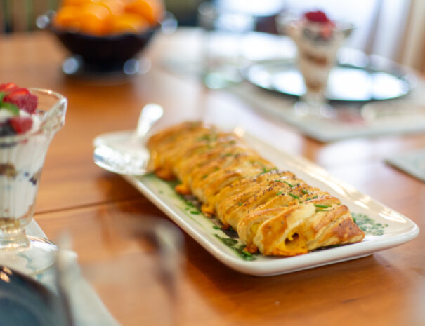 Table set with braided breakfast plated in the center.